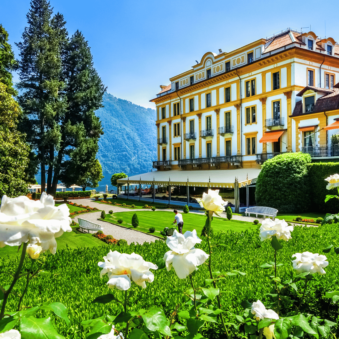 luxury hotel in front of tall trees and mountain