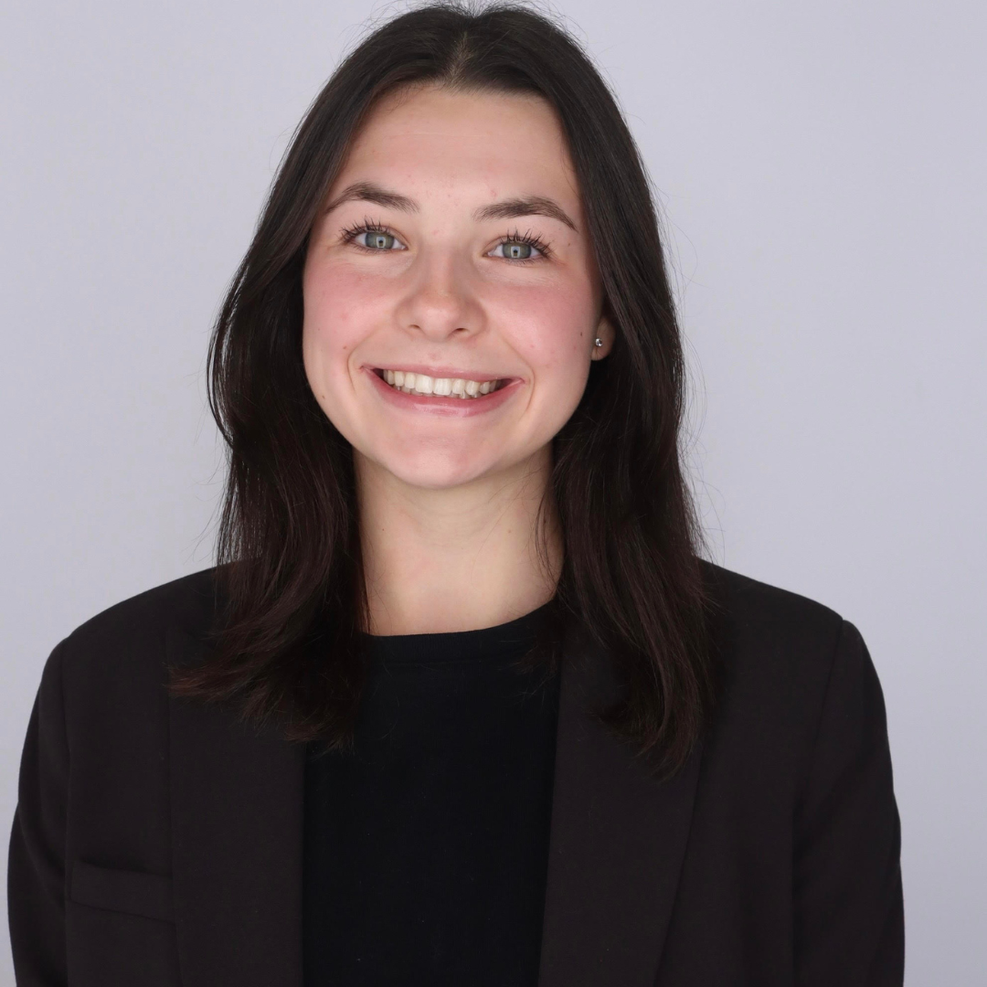 young woman in black shirt smiling at the camera