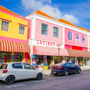 colorful caribbean buildings with cars out front