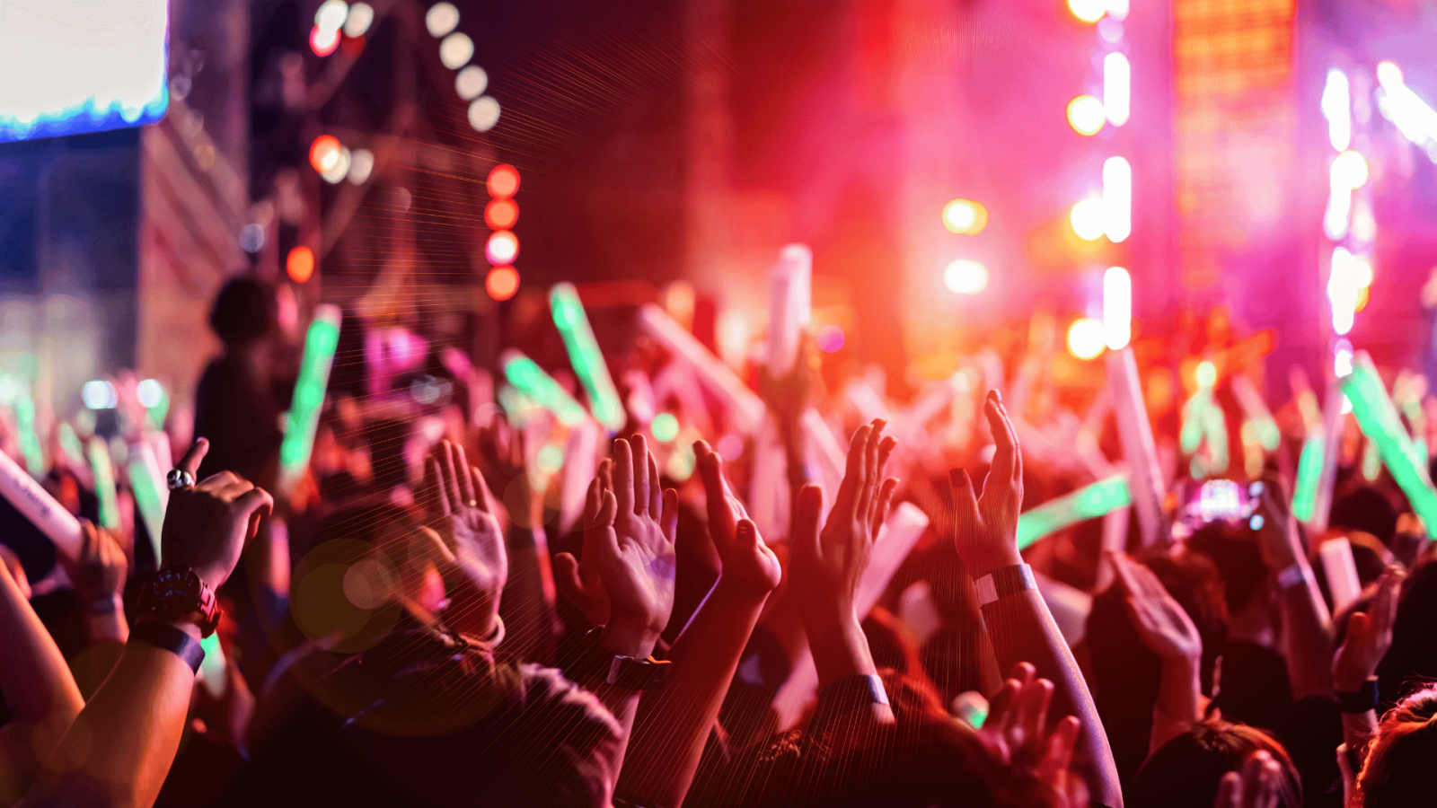 hands in the air at concert at night